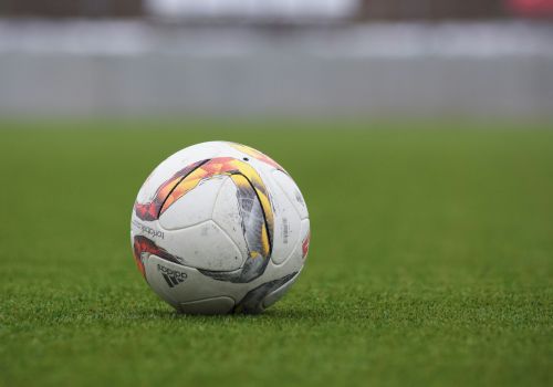 A soccer ball on a grass field, with a blurred background.