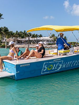 The image shows five people on a boat with 